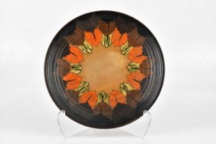 CHARLOTTE RHEAD; wall charger, decorated with leaves, diameter 37cm.