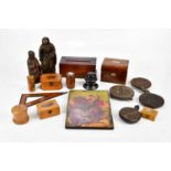 A collection of treen items to include two carved oak figures, four carved oak biscuit stamps,