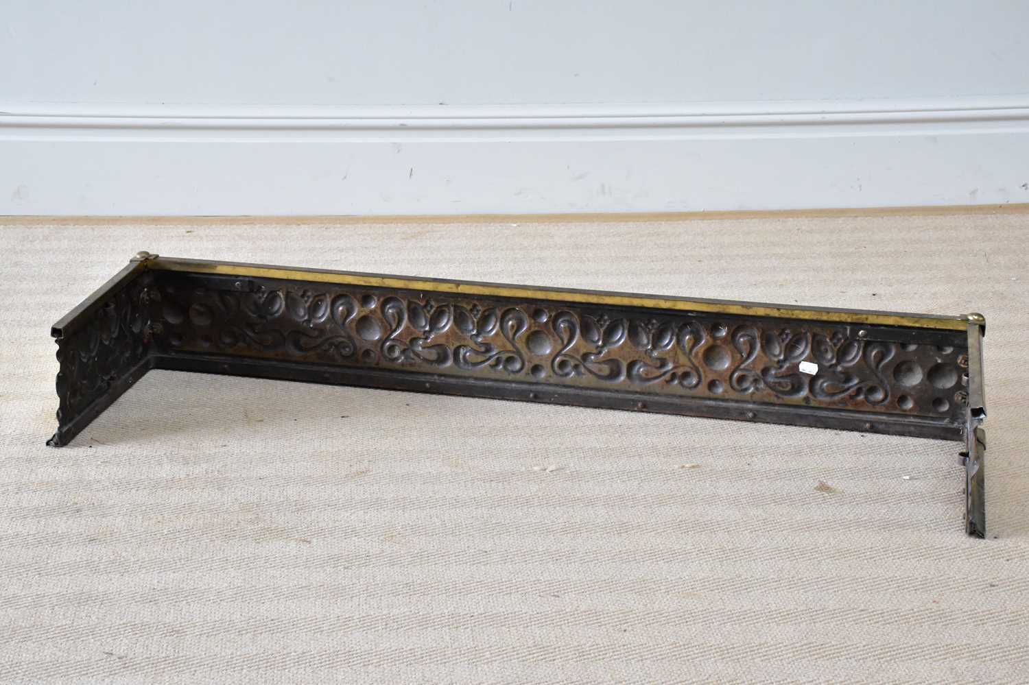 An Art Nouveau brass fender with embossed scrolling and floral decoration, length 129cm. - Image 2 of 2