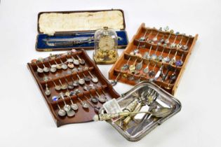 A collection of assorted plated items including souvenir spoons, a bowl with swing handle, a cased