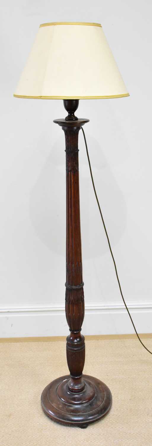 An early 20th century carved standard lamp with floral and fluted decoration, height 144cm.