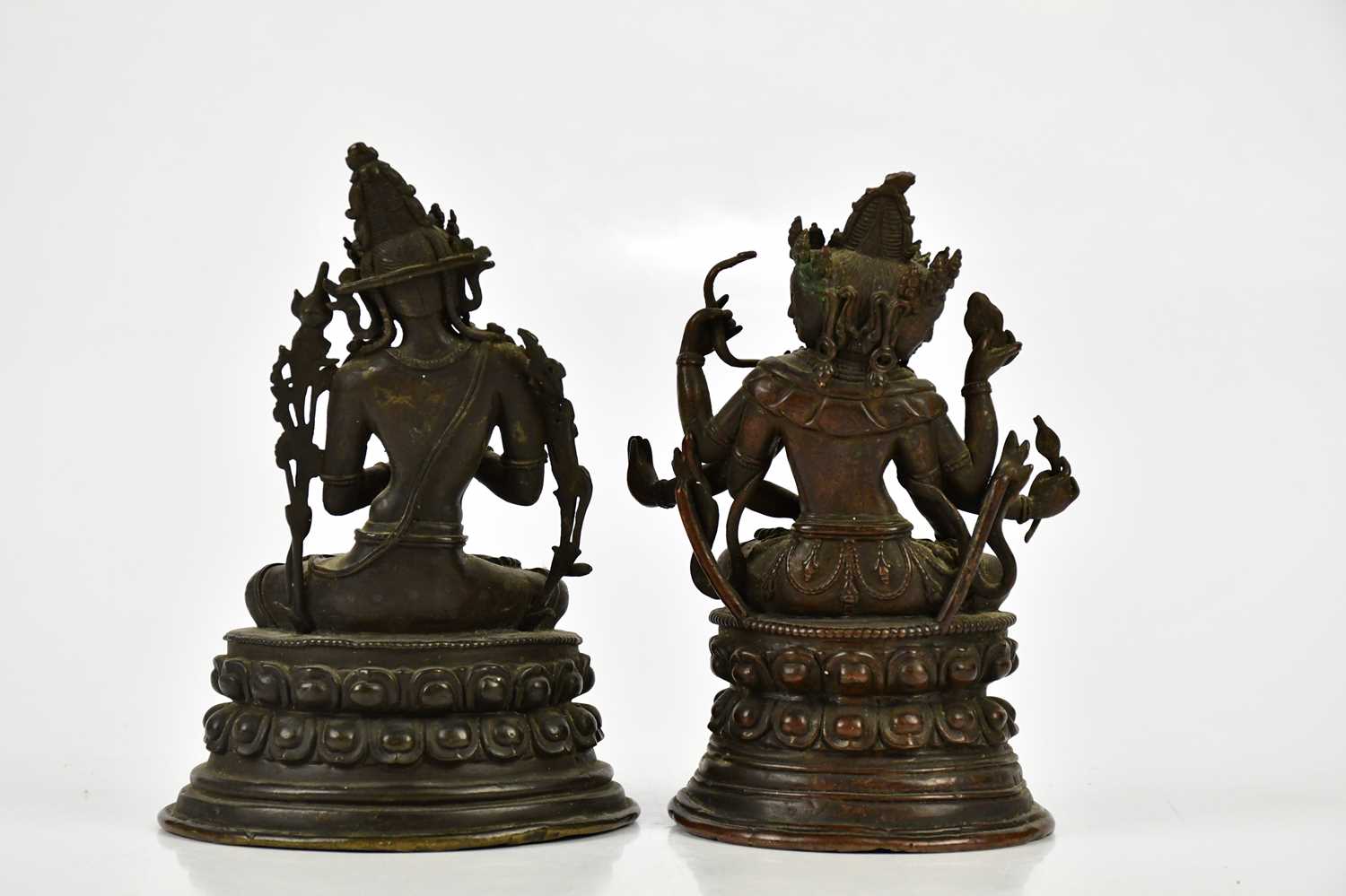 A Chinese bronze figure of a female deity with four arms, with leaf shaped back plate and oval base, - Image 6 of 6