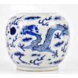 A late 19th century Chinese blue and white globular vase, decorated with a four claw dragons chasing
