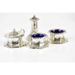 HENRY CLIFFORD DAVIS; a hallmarked silver George V four piece cruet, with blue glass lining,