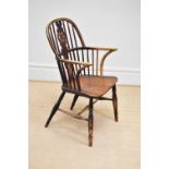 A 19th century elm seated Windsor elbow chair on turned column legs.