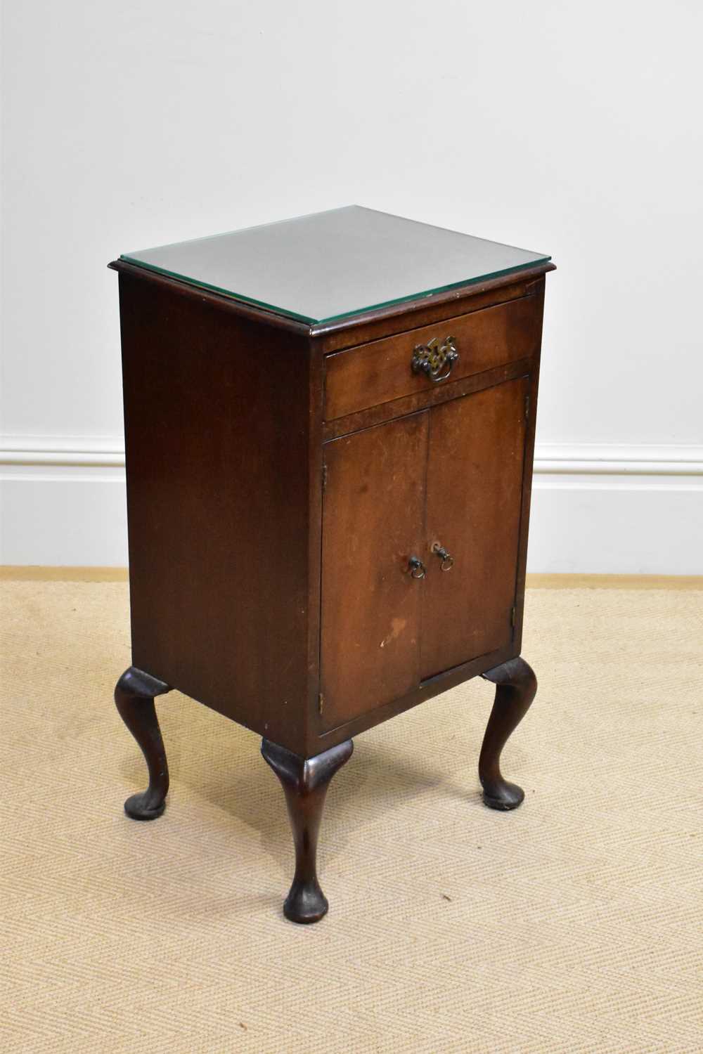 An early 20th century mahogany bedside cabinet with one drawer above two cupboard doors, height