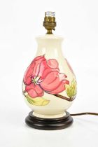 MOORCROFT; a baluster shaped table lamp in the 'Magnolia' pattern, on plinth, height including