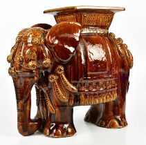 A treacle glazed elephant garden seat, height 48cm.