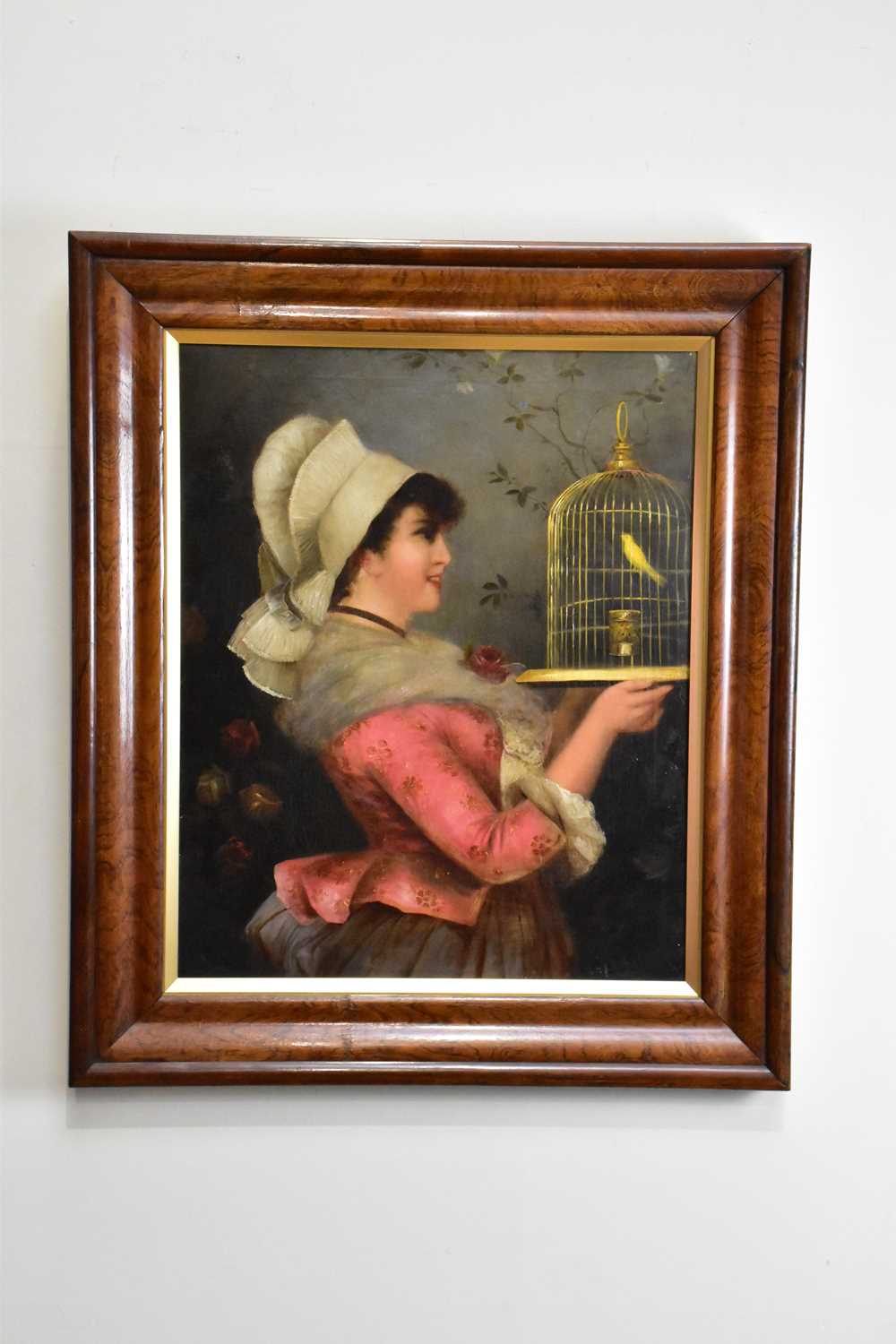 F RUST, 19th CENTURY; oil on canvas, portrait of a maiden in a floral pink top holding a cage with a