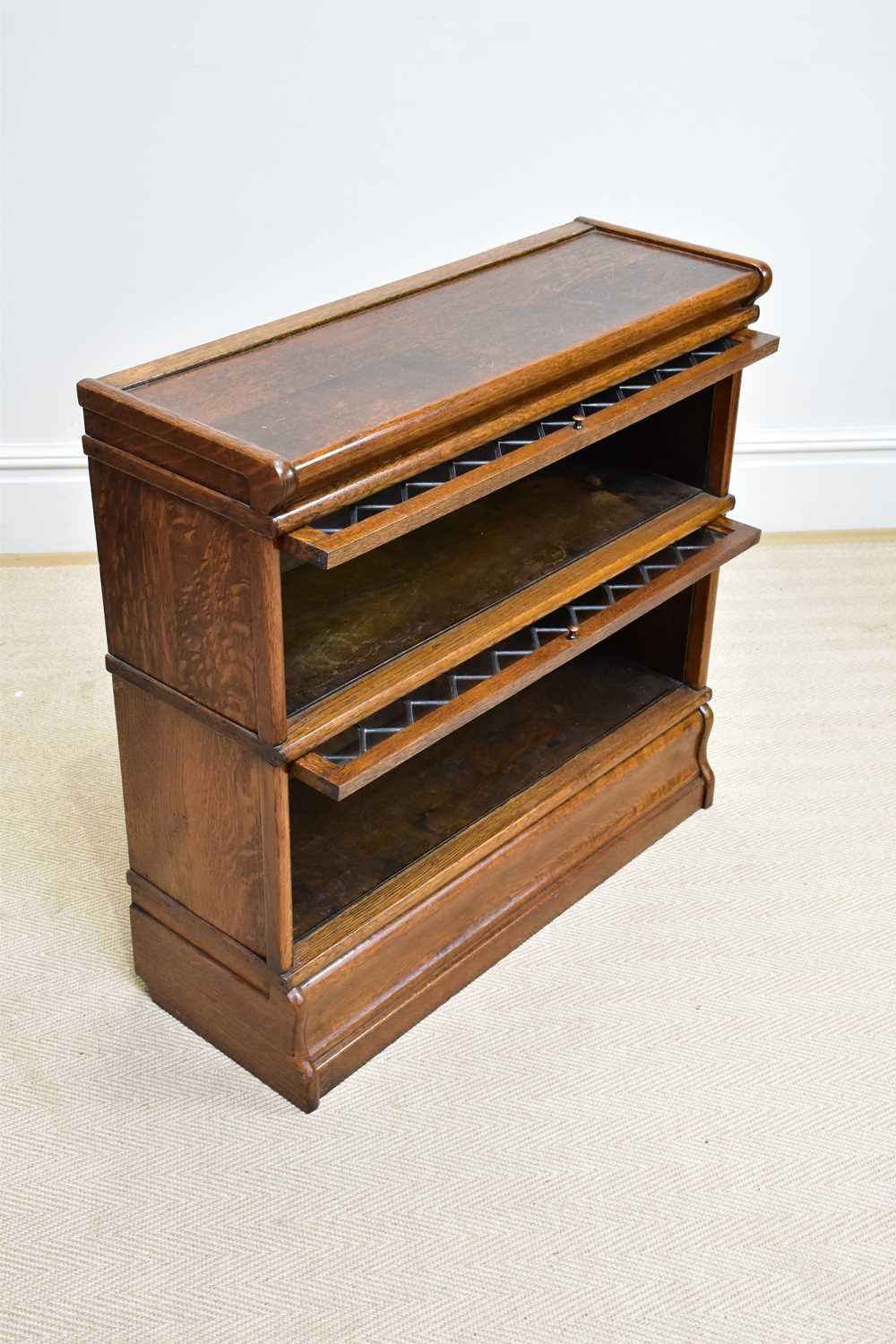 GLOBE WERNICKE; an oak two tier metal bound stacking bookcase with leaded glazed up and over door, - Image 2 of 4