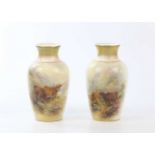 HARRY STINTON FOR ROYAL WORCESTER; a pair of hand painted vases decorated with Highland cattle,