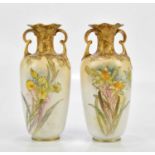 DOULTON BURSLEM; a pair of twin handled vases with wavy rims, each with hand-painted floral