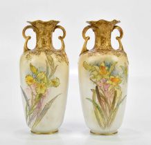 DOULTON BURSLEM; a pair of twin handled vases with wavy rims, each with hand-painted floral