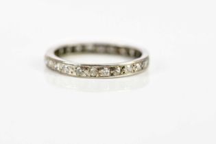 A white metal diamond set eternity ring, size O, approx 3g.