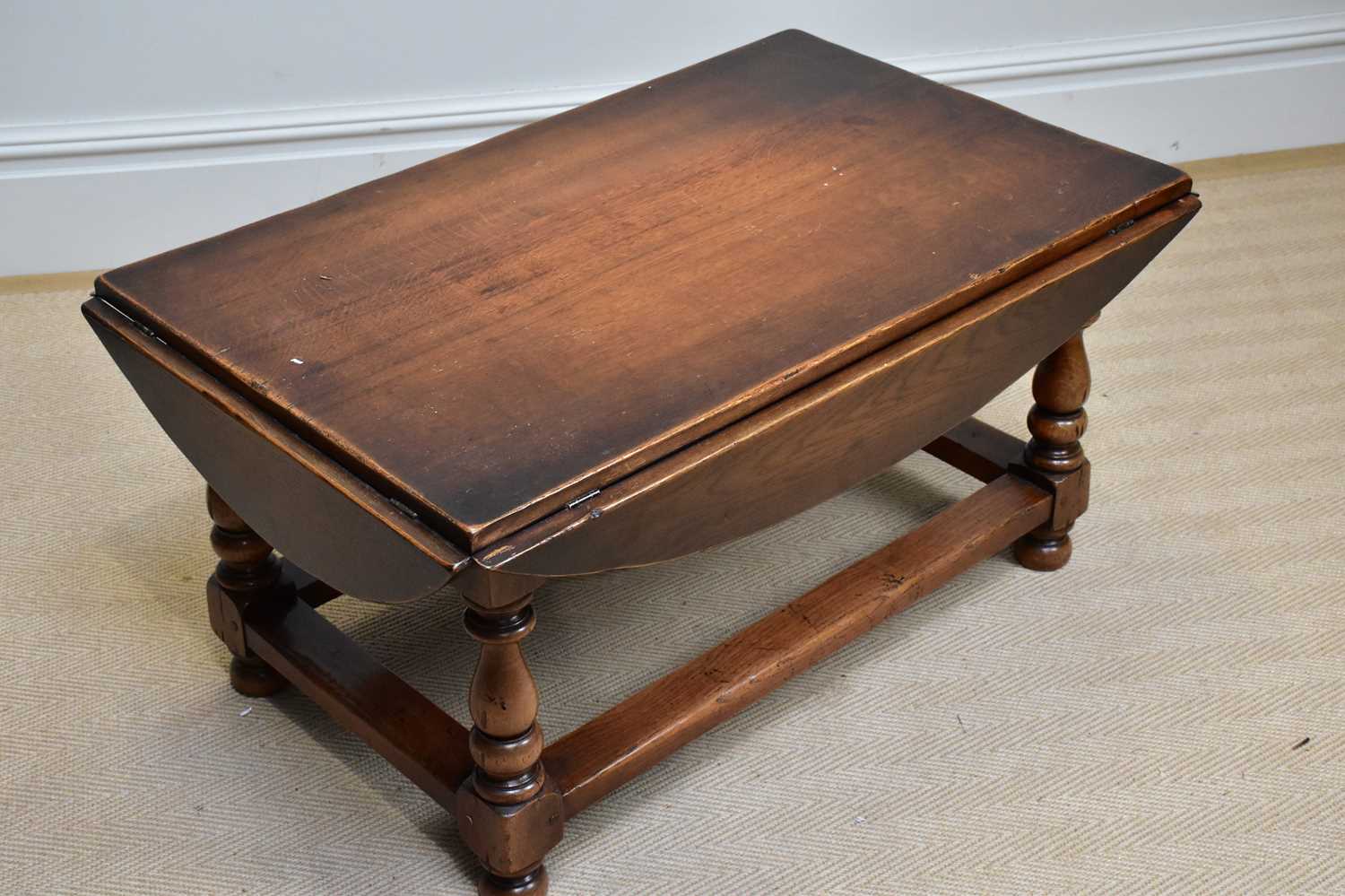 A reproduction oak drop-leaf coffee table of rectangular form, on bun feet, width 95cm, height - Image 3 of 3