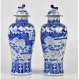 A pair of 19th century Chinese blue and white porcelain vases with associated covers, each decorated