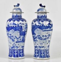 A pair of 19th century Chinese blue and white porcelain vases with associated covers, each decorated