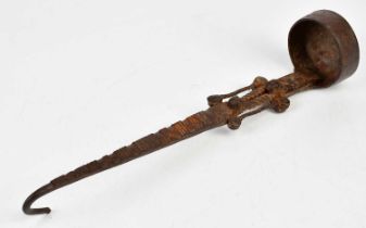 A 17th century wrought iron ladle with open decoration of simple rivets, length 34cm.