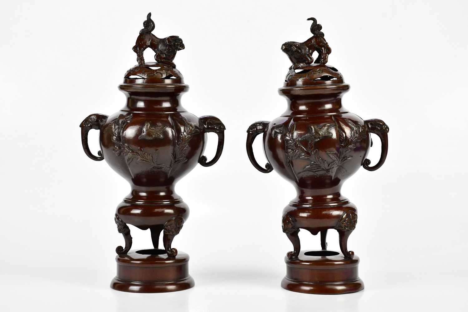 A pair of Japanese Meiji period koros and covers, the pierced covers mounted with Dogs of Fo above