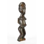 A carved African figure, height 49cm. Condition Report: There are splits running throughout, chips