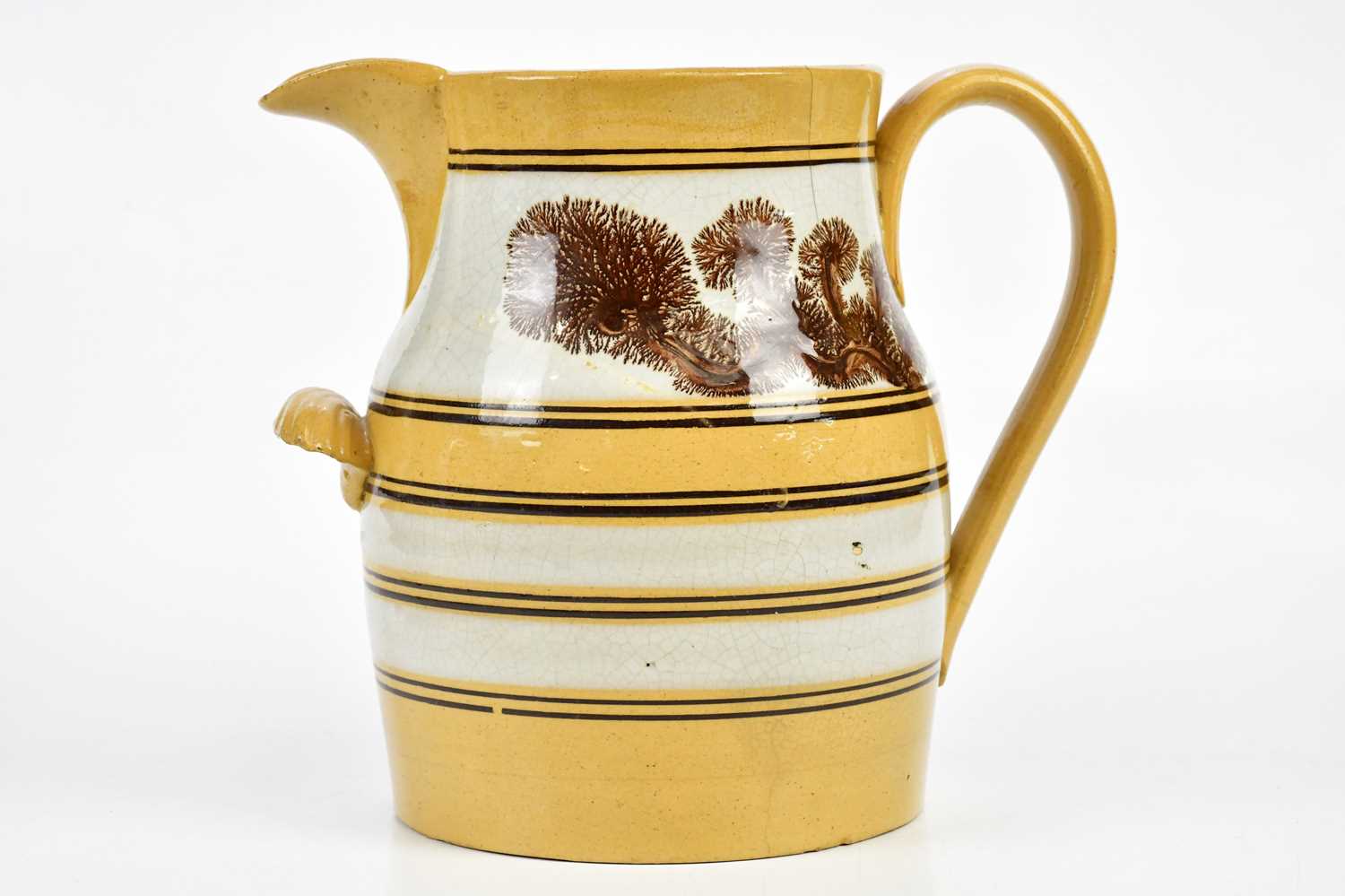 A 19th century Mocha ware jug, decorated with a pale yellow glaze, height 30cm. Condition Report: