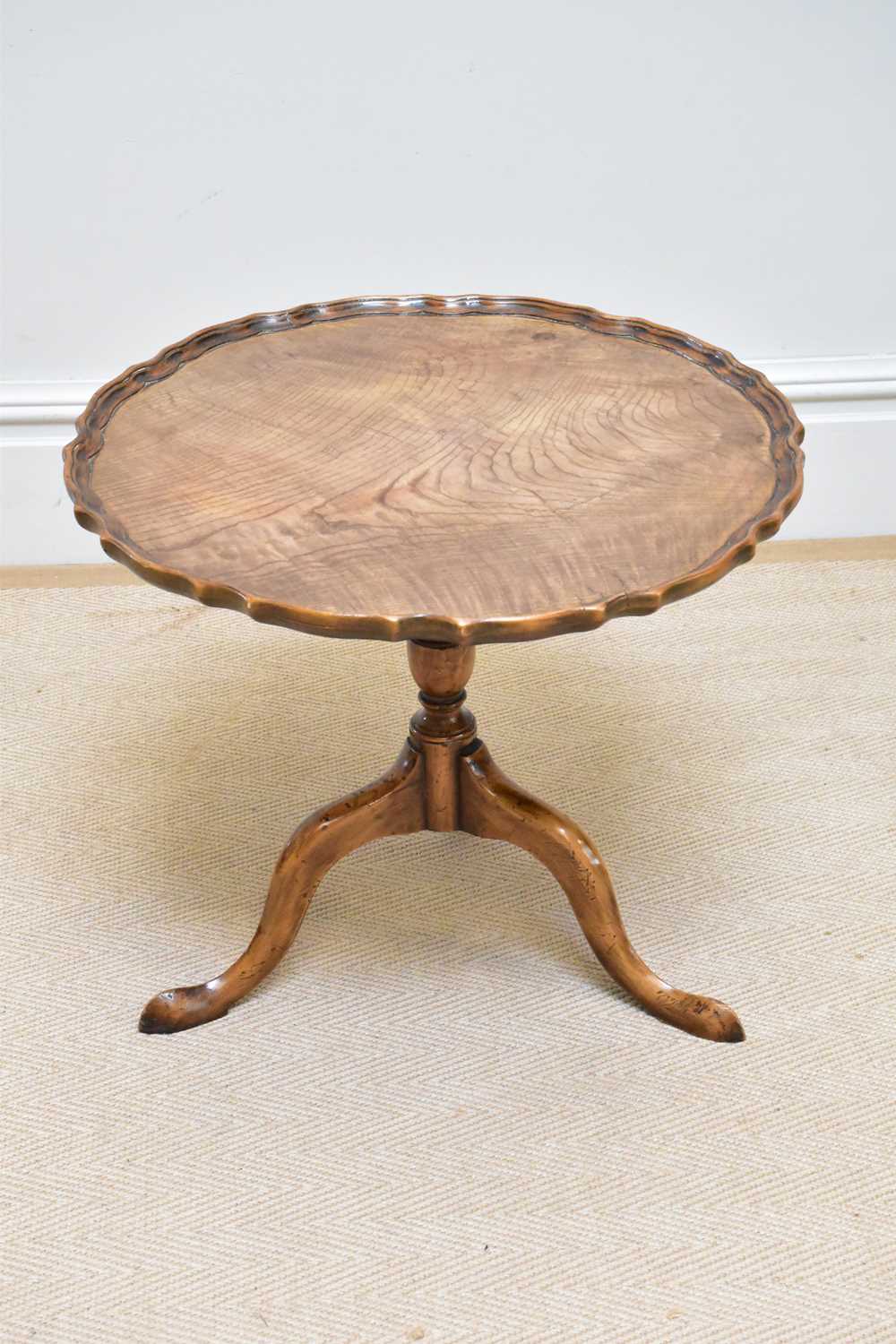 A George III style walnut tripod table, diameter 59cm.