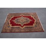 A red ground machined Tabriz style carpet, 347 x 249cm.