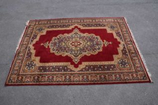 A red ground machined Tabriz style carpet, 347 x 249cm.