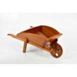A reproduction miniature wheelbarrow, length 46cm.