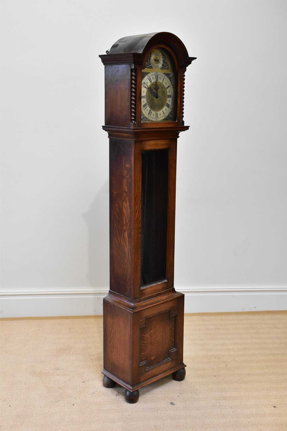 An early 20th century oak longcase clock, with St Michael Westminster and Withington chimes, on