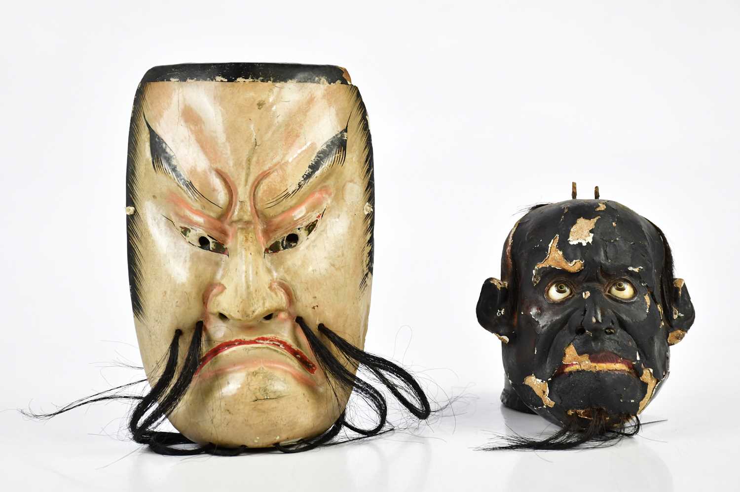 Two painted wooden 1930s face masks, largest 19cm.