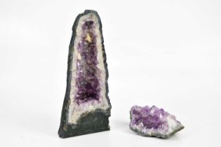 A large Brazilian amethyst pillar, height 36cm and a similar smaller fragment (2).