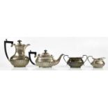 HENRY MATTHEWS; a George V hallmarked silver four piece tea service with gadrooned decoration,