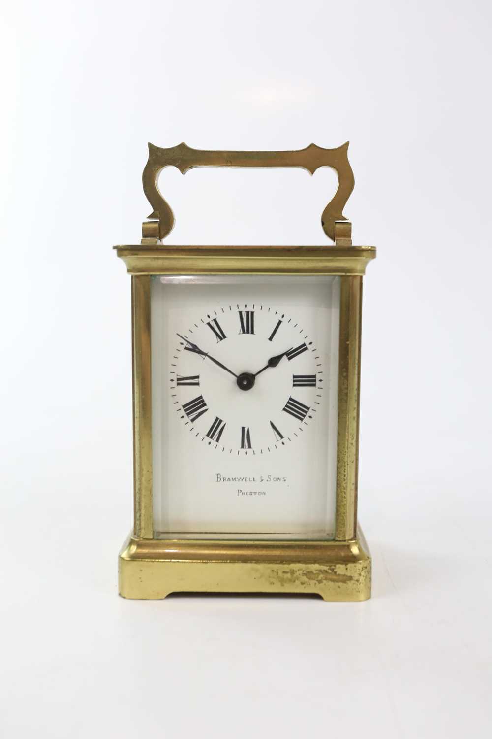 BRAMWELL & SONS; a French brass carriage timepiece, height with handle down 11.5cm, with leather