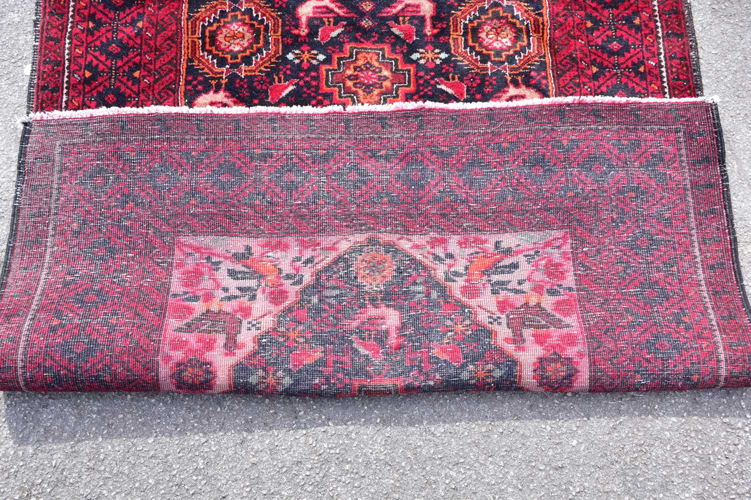 A red ground wool carpet with geometric pattern to the centre, 200 x 100cm. - Image 3 of 3