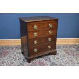 A late George III oak chest, with four graduated long drawers with oval brass handles decorated with