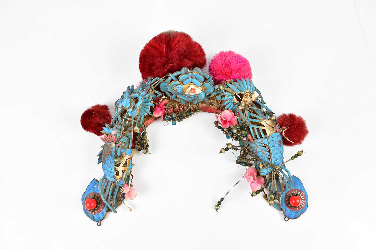 A Chinese Peking opera headdress with applied turquoise silk and jewelled decoration.