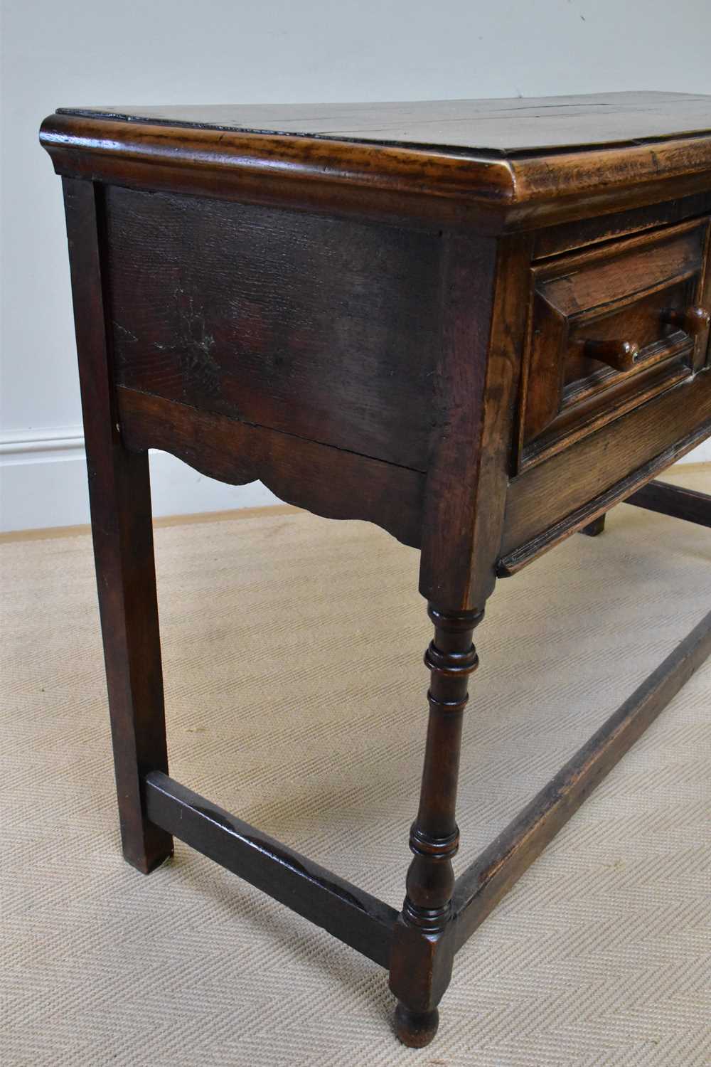 An 18th century style oak dresser base with three drawers, on bun feet, width 133cm, depth 47cm, - Image 2 of 3