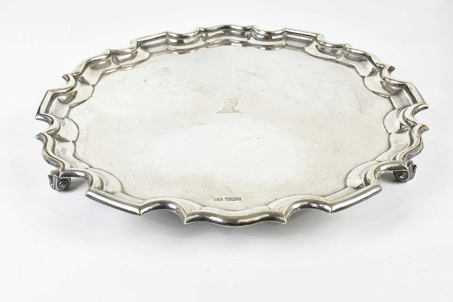 LEE & WIGFULL; a George V hallmarked silver salver with pie crust edge and central family crest,