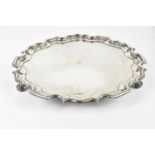 LEE & WIGFULL; a George V hallmarked silver salver with pie crust edge and central family crest,