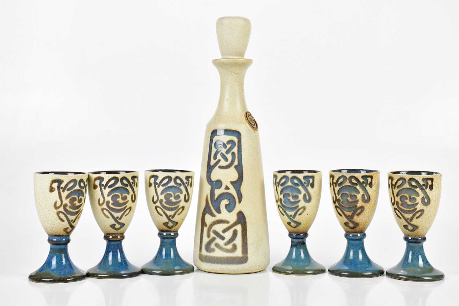 LAUGHARNE WALES POTTERY; a set of six ceramic goblets and a wine decanter, height 35cm.