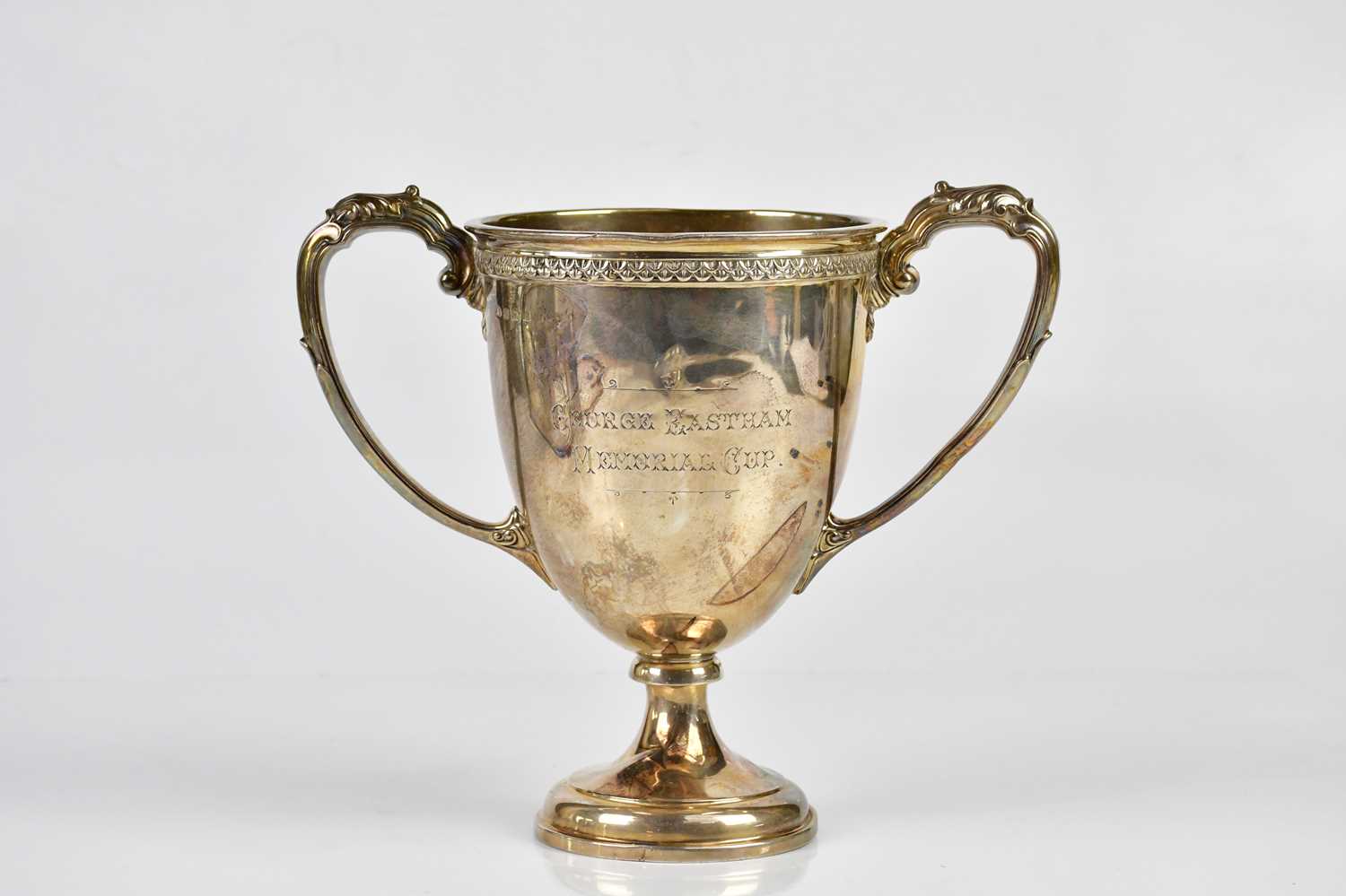 ADIE BROS LTD; a George V hallmarked silver twin handled pedestal trophy cup, inscribed 'George
