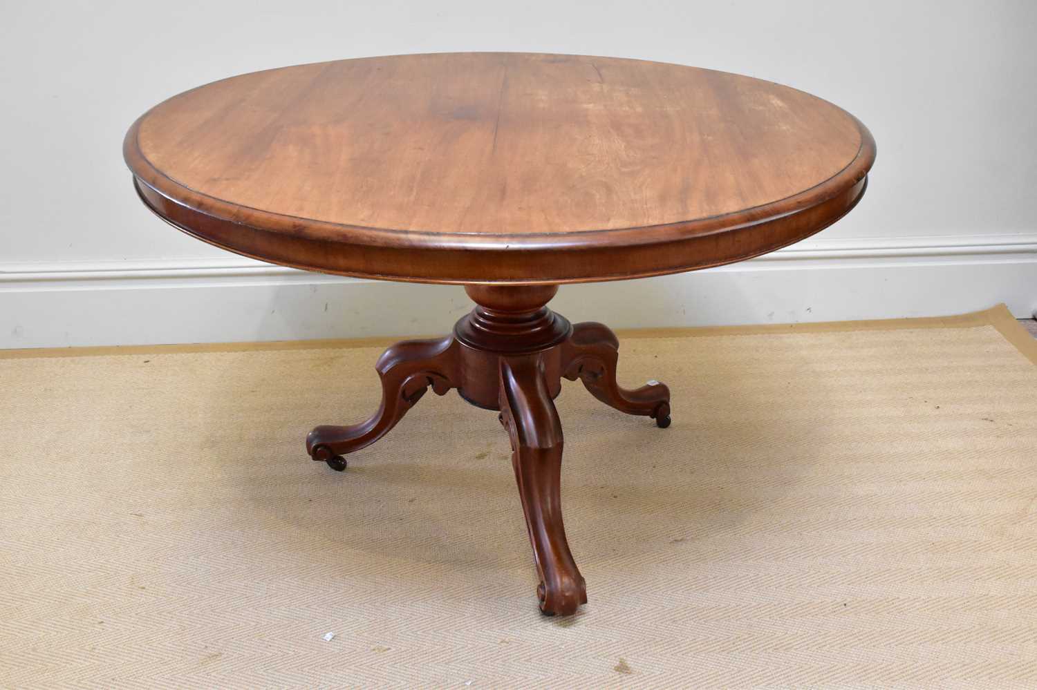 A Victorian mahogany tilt-top breakfast table on baluster and scrolling legs, diameter 114cm.