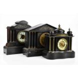 Three Victorian eight day black slate mantel clocks, tallest 37cm (3).