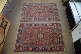 An Eastern style rug with floral and stylised decoration, approx 202 x 136cm, and a similar