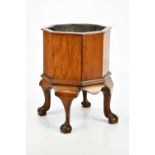 A late 19th century octagonal oak cellarette with four cabriole supports to ball and claw feet, with