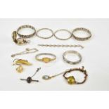 A collection of assorted costume jewellery including a white metal snap bangle, a heart shaped