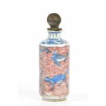 A 19th century Chinese porcelain snuff bottle, decorated with stylised animals and shells, below