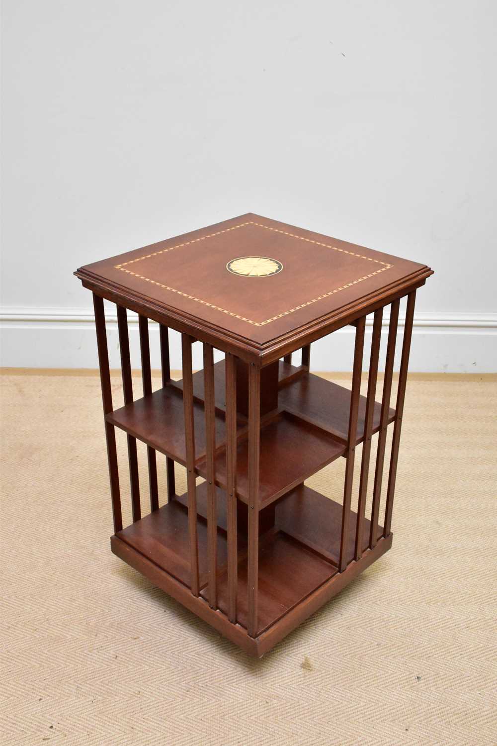 A reproduction inlaid mahogany revolving bookcase, height 77cm.