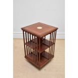 A reproduction inlaid mahogany revolving bookcase, height 77cm.